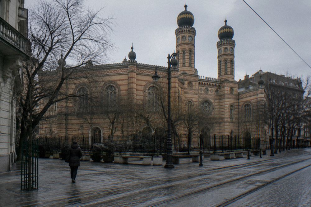 City square in Budapest with historic facades and a tram line