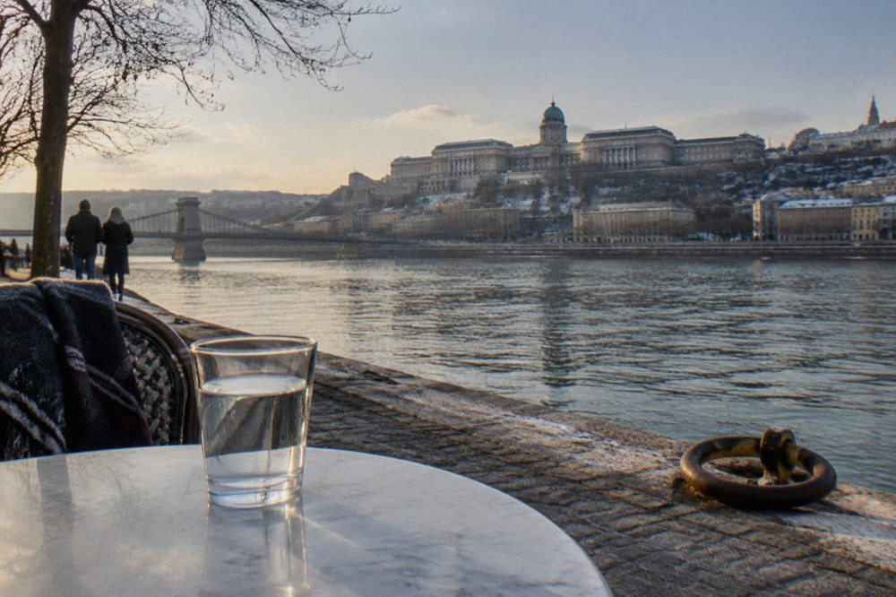 A full glass of water standing on a Budapest cafe table