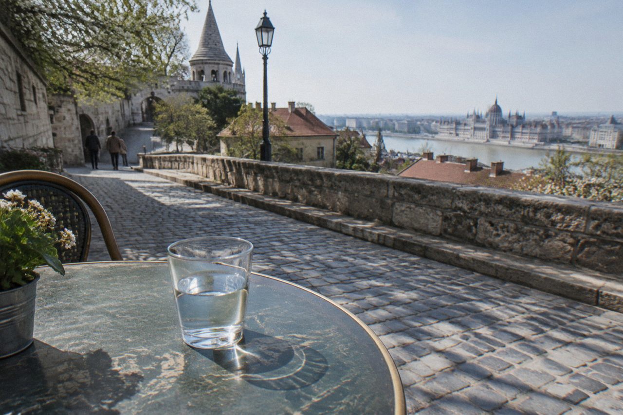 A glass of water on a marble cafe table in Budapest