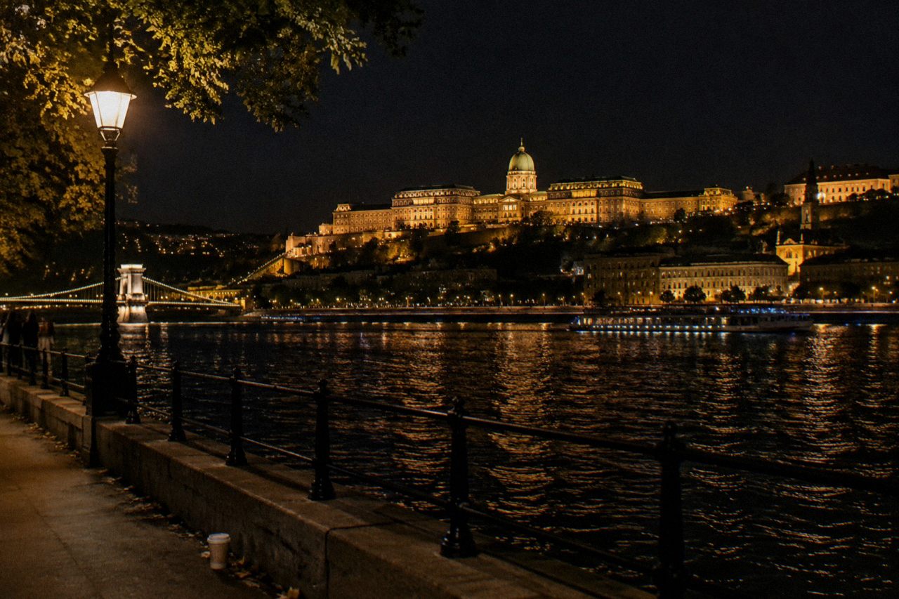 Buda Castle hill and its lit walls seen from across the Danube at night