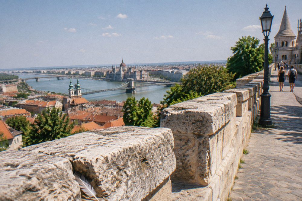 Stone ramparts and rooftops of the Buda Castle District in daylight