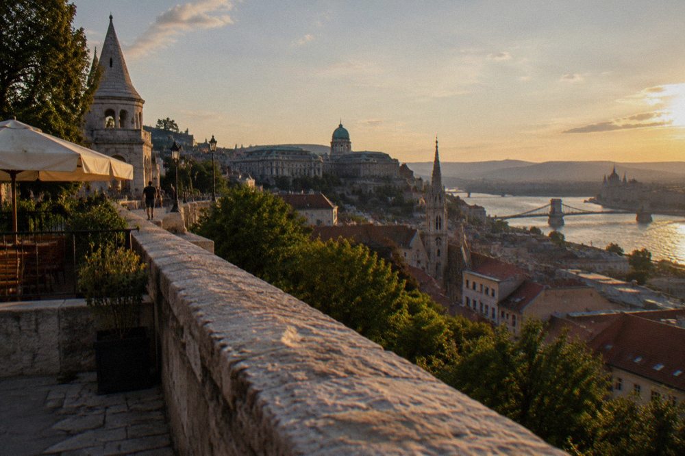 Sunlit terracotta rooftops of Budapest seen from the Castle Hill ramparts