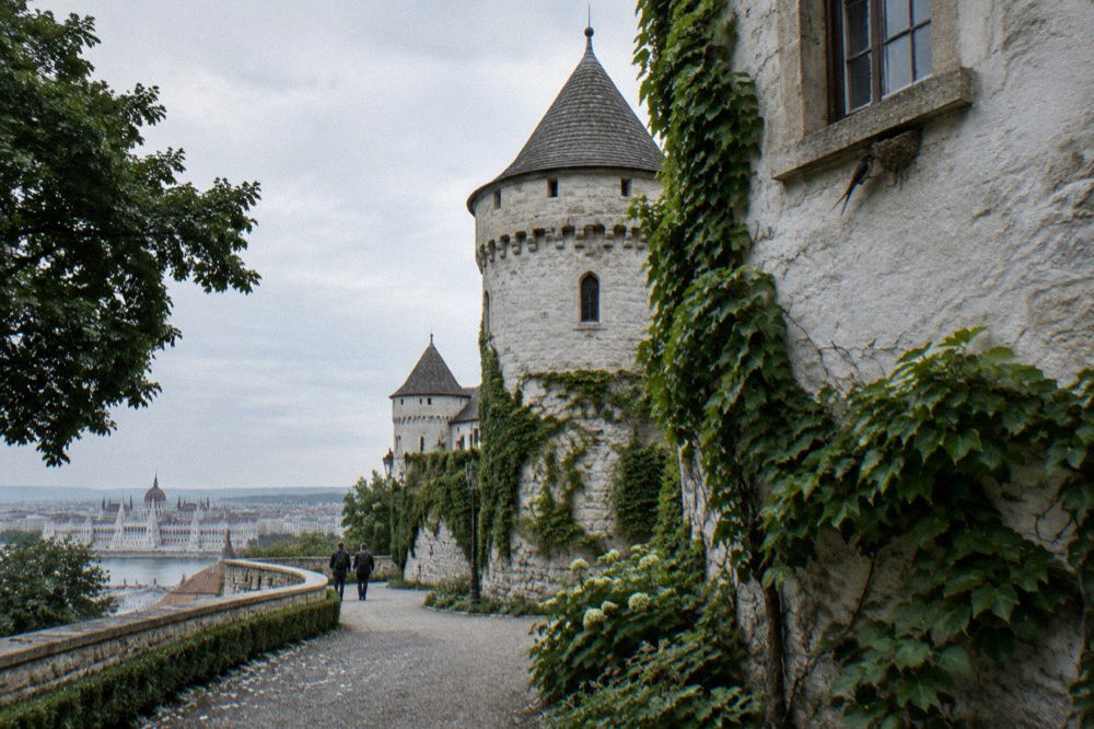White stone walls and towers of the Buda Castle district under a clear summer sky