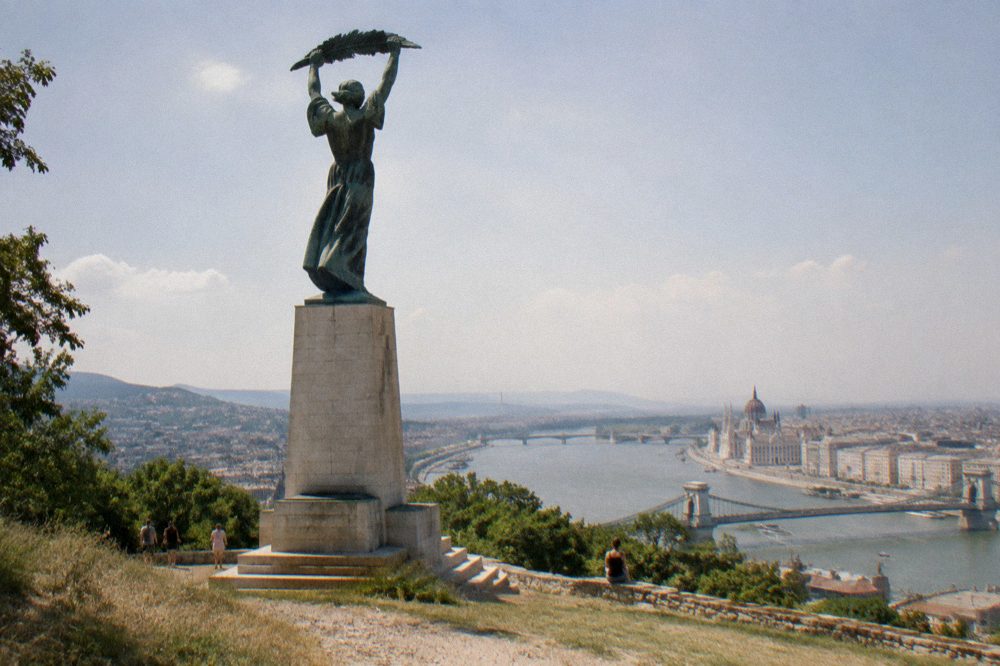 Liberty Statue on Gellert Hill against a wide summer sky above Budapest