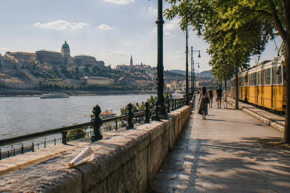 Tram running along the Danube embankment in Budapest in bright summer light