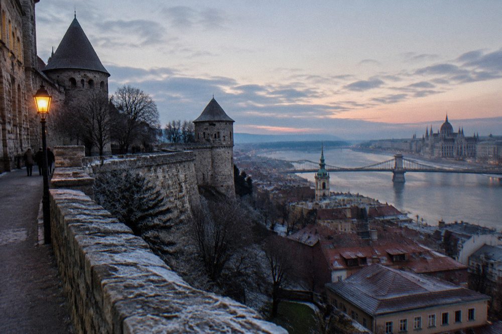 Medieval castle walls and tiled rooftops above the Danube in Budapest