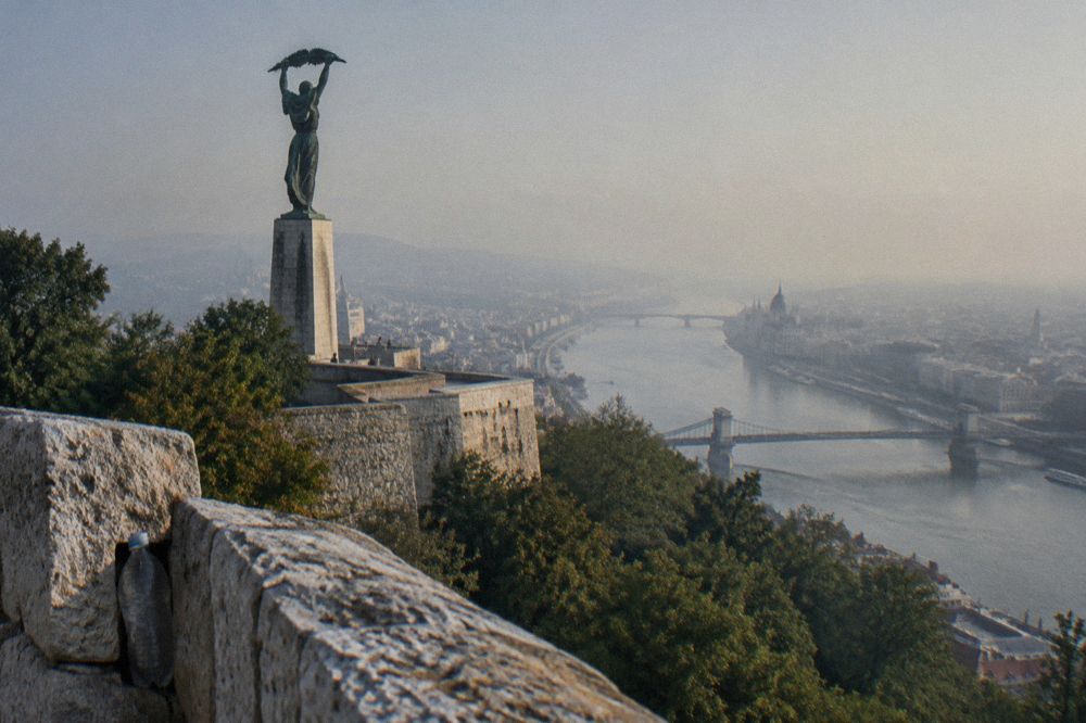 The Liberty Statue on Gellért Hill above the city, with the fortress walls of the Citadella.