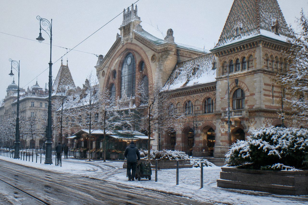 The covered Great Market Hall in Budapest seen from the square outside, with its tiled roof and iron structure.