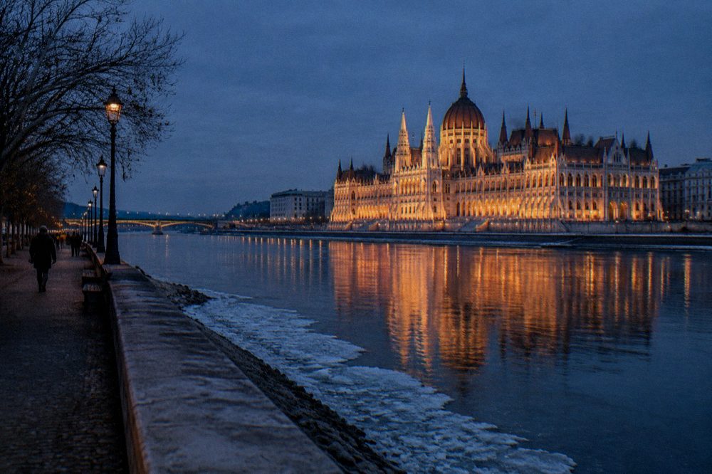 The Hungarian Parliament facade reflected in the Danube at dusk